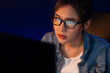 © Summit Art Creations - Portrait young beautiful Asian creative with glasses of serious face looking on pc to search project creator social media online, planning strategy creator at neon modern office at night. Stratagem.