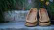 © Elnare - A pair of woven straw sandals on a stone step.