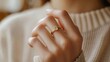 © Nicat - A natural stone ring on the finger of a sophisticated woman. The female model wears a sophisticated gold ring on her finger. Pictures of jewelry for e-commerce, social media, and other platforms
