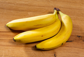 Wall Mural - Sweet fresh banana fruit in peel lies on table