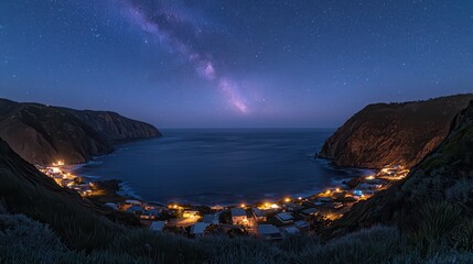 Wall Mural - Stunning Night Sky Over Coastal Village with Milky Way Galaxy Visible Above Ocean Cove and Surrounding Hills