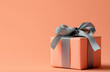 © Sekai - Subtle Charm: Peach Gift Box with a Grey Ribbon on Peach Background