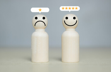 Customer service rating in five stars as an excellent employee in the company on wooden table background. Wooden miniature figurine theme. Business corporation and management concept..