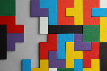 Poster - Colorful wooden puzzle pieces on light grey background, top view