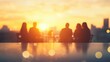 © tashechka - A group of professionals engages in discussion at a meeting, set against a stunning sunset with a city skyline backdrop