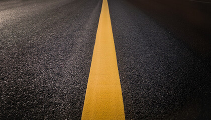 Black Road is a black concrete road with a yellow line in the middle.