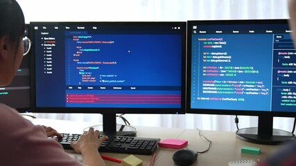 Slow motion back end software developer engineer for computer programming working together on debugging writing computing code, solving complex algorithms display on monitor in office. Burgeoning