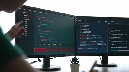 Slow motion back end software developer engineer for computer programming working together on debugging writing computing code, solving complex algorithms display on monitor in office. Burgeoning