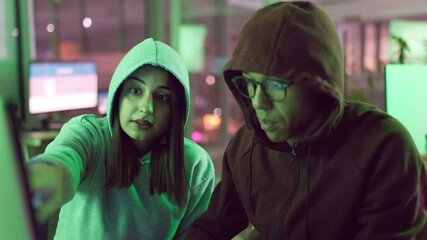 Poster - Hacker, people and cybercrime in office, night and discussion of couple, identity theft and malware. Hoodie, pointing and criminals in rush, digital and stealing of info for ransomware and coding