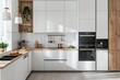 © kitipol - Minimal white kitchen with cozy wooden accents and modern appliances