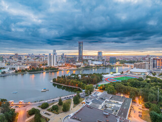 Wall Mural - Yekaterinburg city and pond aerial panoramic view at summer or early autumn sunset. Night city in the early autumn or summer.