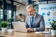 © Introvertia - Focused businessman working on laptop in modern office