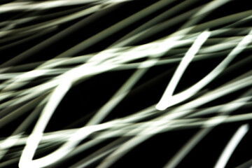 Wall Mural - a blurry image of white lines that are all different lengths. the image is black and white and has a