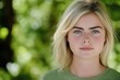 © Mark G - A close-up portrait of a young white woman wearing a casual t-shirt, with a blurred background.