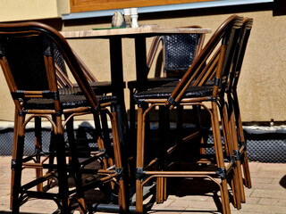 wicker bar chairs and tables in the outdoor restaurant. beautiful seating high above the ground