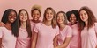 © lenblr - Diverse group of women wearing pink shirts are hugging each other and smiling on a pink background
