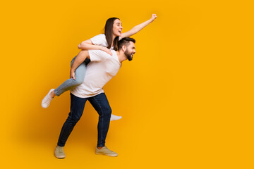 Canvas Print - Full length photo of lovely young guy girl flying superhero piggyback dressed stylish white garment isolated on yellow color background