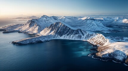 Aerial view of a snowy mountain surrounded by tranquil water