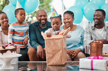 Wall Mural - Big family, child and gift at birthday party with grandparents, gathering or event in lounge. African people, celebration and excited kid with opening box, happiness and cheerful as community in home