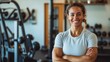 © CreativeSeven  - Confident Female Athlete Smiling in Modern Gym with Fitness Equipment in Background