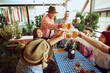 © master1305 - Group of cheerful people, friends meeting at bar for cheerful celebrating, drinking beer, clinking glasses and spreading joy. Concept of Oktoberfest, festival, party, brewery, traditions