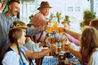 © master1305 - Cheers. Happy, smiling, joyful people,friends gathering at bar, clinking glasses in celebratory toast, enjoying positive meeting. Concept of Oktoberfest, festival, party, brewery and traditions