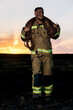 © ADDICTIVE STOCK - Firefighter carrying hoses with dramatic sunset backdrop