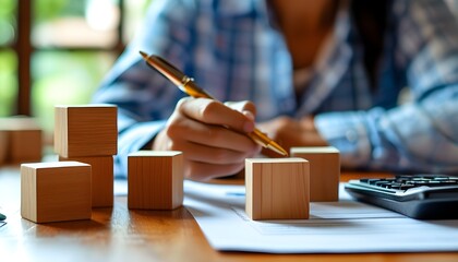 Wall Mural - Financial Planning on Wooden Cubes with Pen and Calculator