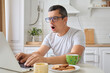 © sementsova321 - Scared surprised man freelancer using laptop with wifi connection working on career and education online shocked by problems while typing and browsing web posing in kitchen at home