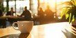 © andyaziz6 - Coffee Cup on Wooden Table with Sunlight and Blurred Background of People in Cafe