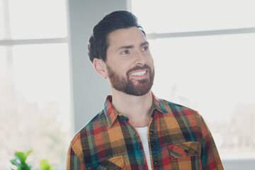 Sticker - Photo of nice young man look interested empty space wear stylish checkered shirt modern light cozy interior flat indoors