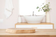 © didecs - Wooden table with pedestal in blur bathroom for bathing and spa product display