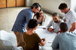 © ThurstanJam/peopleimages.com - Group, planning and business people in meeting, documents and conversation in office. Employees or creative agency or professional with cooperation, teamwork or collaboration for project or paperwork