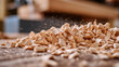 © fotogurme - Close-up of wood shavings curling off a gouge as a craftsman carves wood rich texture in natural light