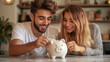© Full_Size - Young Couple putting money into piggy bank, saving money concept. Planning save many for new property