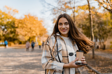 attractive young woman walking in autumn wearing jacket