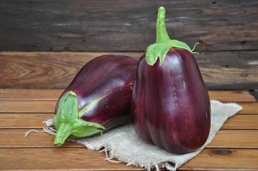 two large ripe eggplants on a wooden table. selective focus. natural farm products