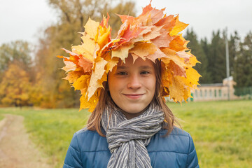 Autumn portrait of a smiling happy girl child in autumn park outdoor