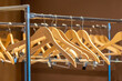 © Mariakray - Wooden hangers on coat rack with no clothes in cloakroom or closet
