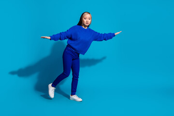 Poster - Full length body photo funny youth philippine girl with dyed hairstyle flying two arms wings isolated on blue color background