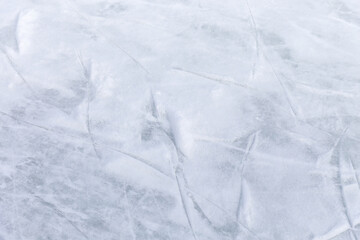 Ice background with marks from skating and hockey, blue texture of rink surface with many scratches