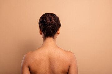 Poster - Photo of stunning dreamy lady back view massage bare shoulders isolated on beige pastel color background