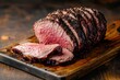 © Vlad - Bottom Round Roast for Roast Beef. Dark Butcher Board Background for Bar-B-Q Cooking