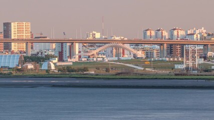 Wall Mural - Park Tejo and river timelapse in Lisbon with park of Nations district modern architecture on a background, Portugal. View with Vasco da Gama Bridge from walking route Percurso Ribeirinho de Loures