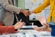 © NINENII - Business team shake hands confidently professional investor working with new startup project at an office meeting.