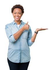 Young beautiful african american woman over isolated background Showing palm hand and doing ok gesture with thumbs up, smiling happy and cheerful