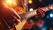 © Suphawan - A close-up of an electric guitar's strings and fretboard, with a musician's hand in focus playing a fast solo, and stage lights in the background.