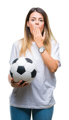 Wall Mural - Young beautiful woman holding soccer ball over isolated background cover mouth with hand shocked with shame for mistake, expression of fear, scared in silence, secret concept