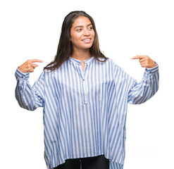 Young beautiful arab woman over isolated background looking confident with smile on face, pointing oneself with fingers proud and happy.