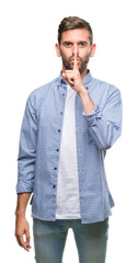 Sticker - Young handsome man wearing white t-shirt over isolated background asking to be quiet with finger on lips. Silence and secret concept.